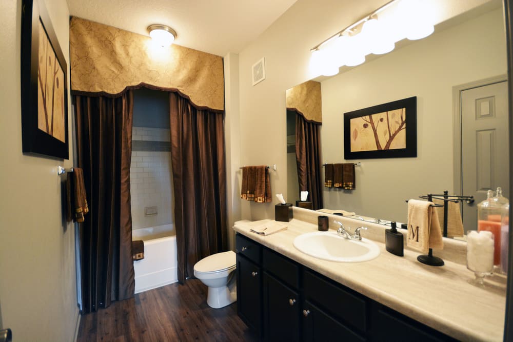 Bathroom with oversized vanity, designer finishes, and tiled shower/tub combination at Estates at McDonough Apartment Homes in McDonough, Georgia