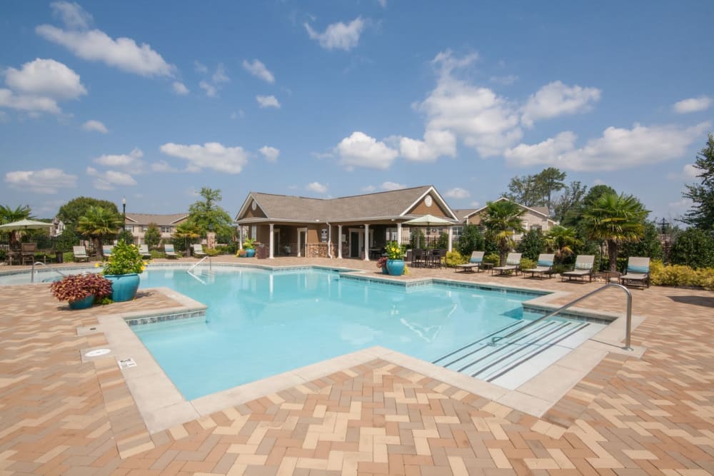 Resort-style pool with sundeck at Estates at McDonough Apartment Homes in McDonough, Georgia