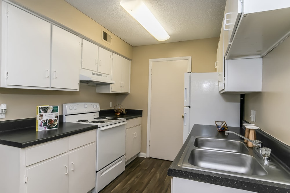 Model kitchen with white cabinetry at Forestbrook Apartments & Townhomes in West Columbia, South Carolina