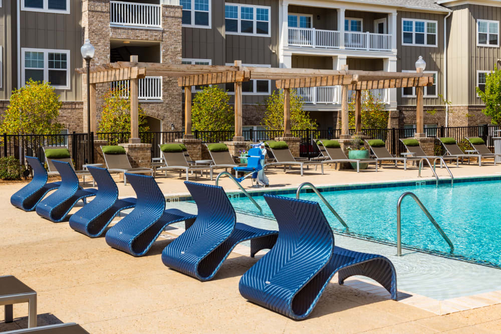 Poolside lounge chairs at Haywood Reserve Apartment Homes in Greenville, South Carolina