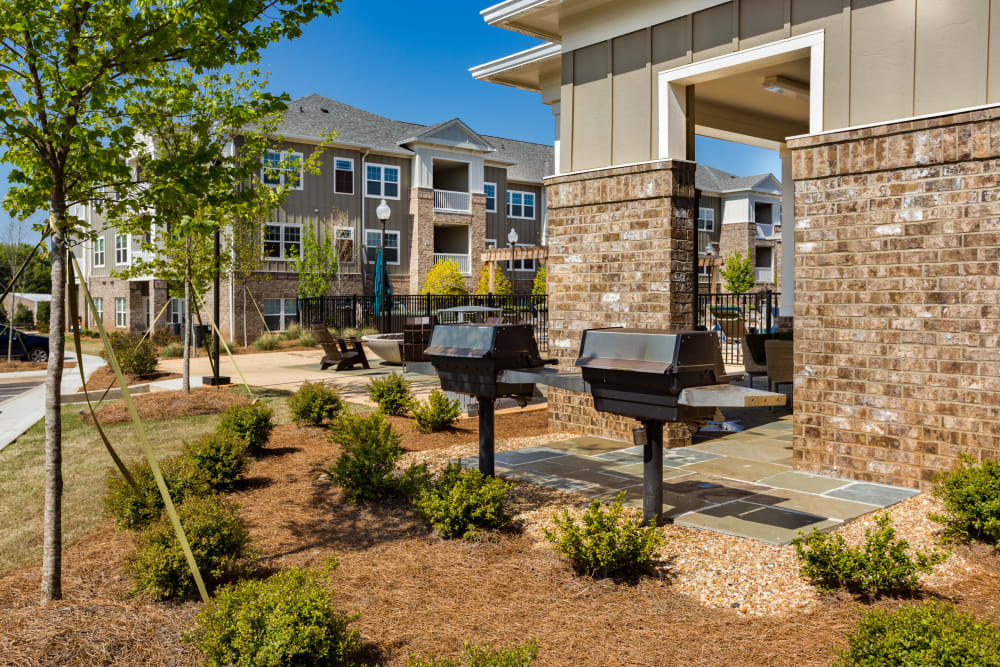 Grills and an outdoor pavilion seating area at Haywood Reserve Apartment Homes in Greenville, South Carolina