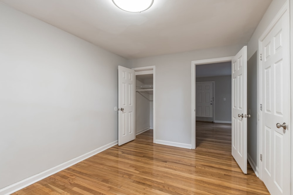 Bedroom with white walls and wood floors at Eagle Rock Apartments at Maplewood in Maplewood, New Jersey