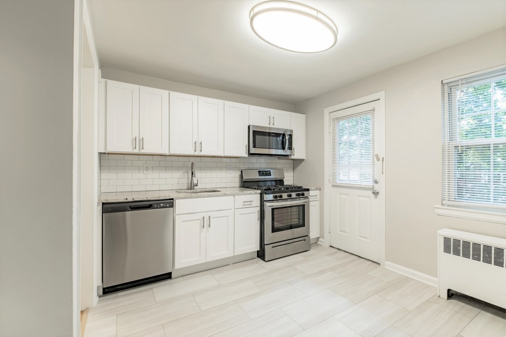 White kitchen with stainless steel appliances at Eagle Rock Apartments at Maplewood in Maplewood, New Jersey