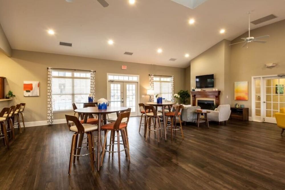 Resident clubhouse with a kitchen and fireplace at Carden Place Apartment Homes in Mebane, North Carolina