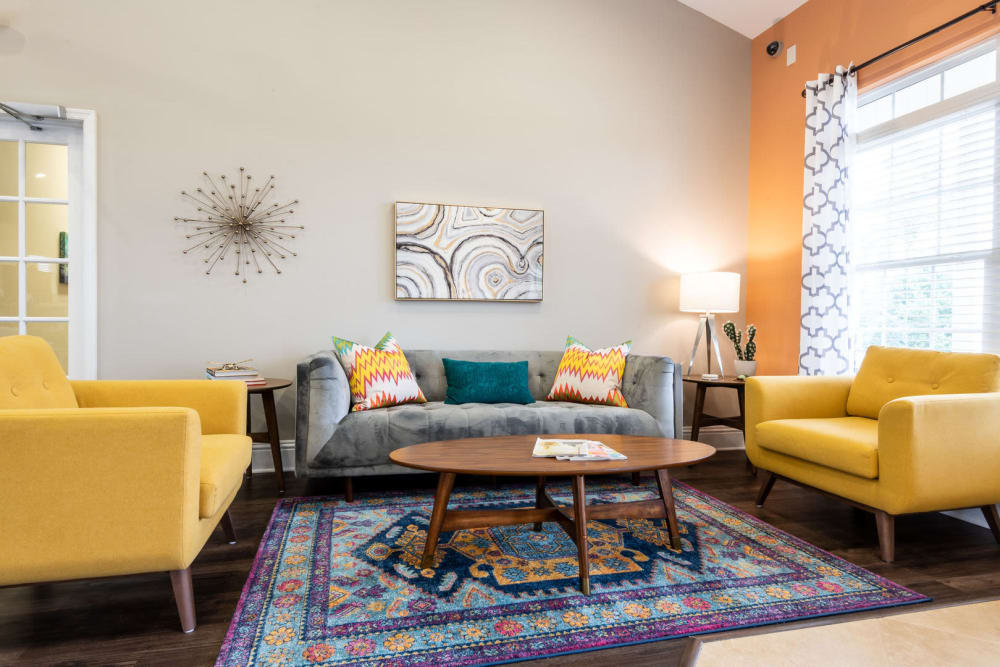 Bright and inviting seating area in the resident clubhouse at Carden Place Apartment Homes in Mebane, North Carolina