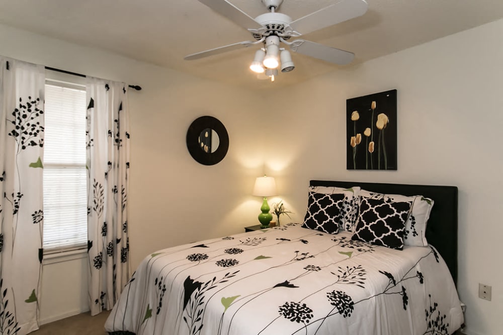 Model bedroom with a ceiling fan at The Waterford Apartments in Columbia, South Carolina