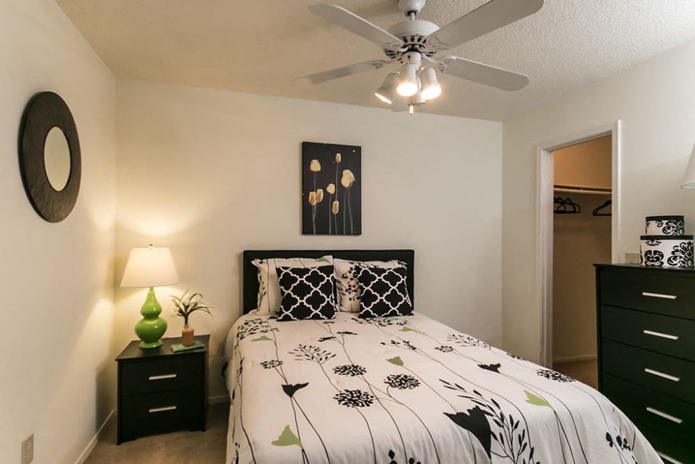 Model bedroom with a walk-in closet and ceiling fan at The Waterford Apartments in Columbia, South Carolina