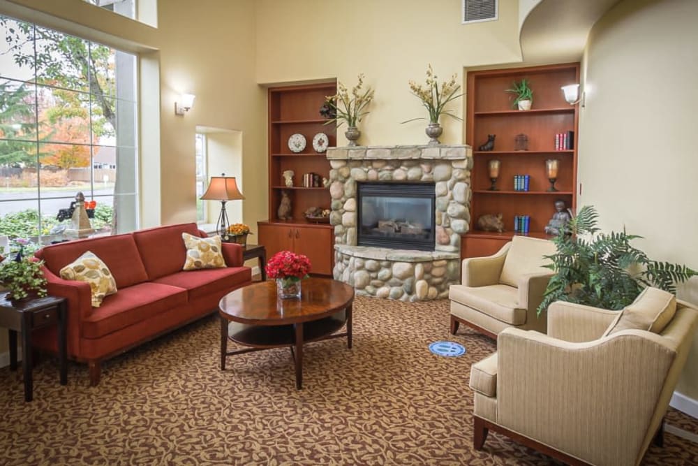 Cozy seating area with chairs and bookcases at Evergreen Memory Care in Eugene, Oregon. 
