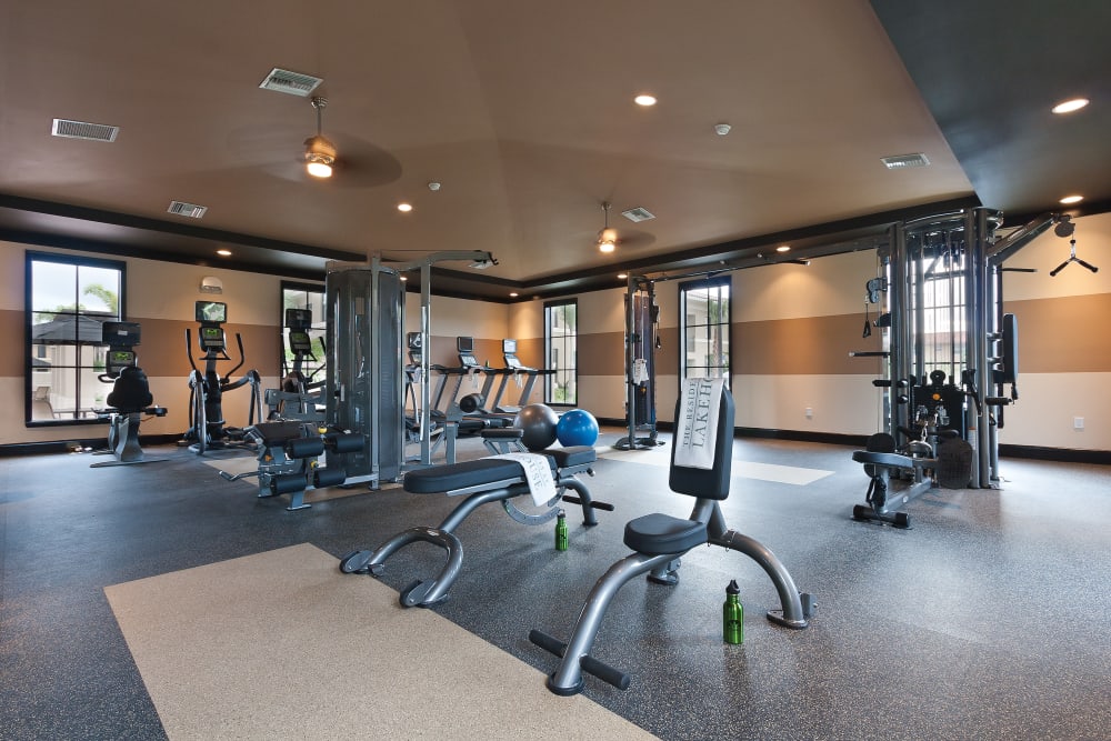 Spacious fitness center with a variety of cardio and strength-training equipment at The Residences at Lakehouse in Miami Lakes, Florida