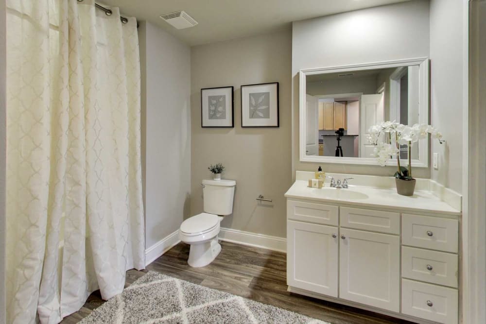 Upgraded model bathroom with white cabinetry at SouthPark Morrison in Charlotte, North Carolina