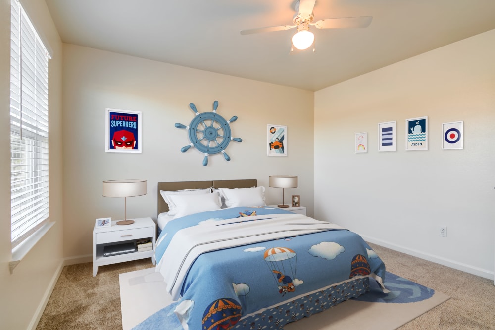 A bedroom with children's furniture in a home at The Village at Serra Mesa in San Diego, California