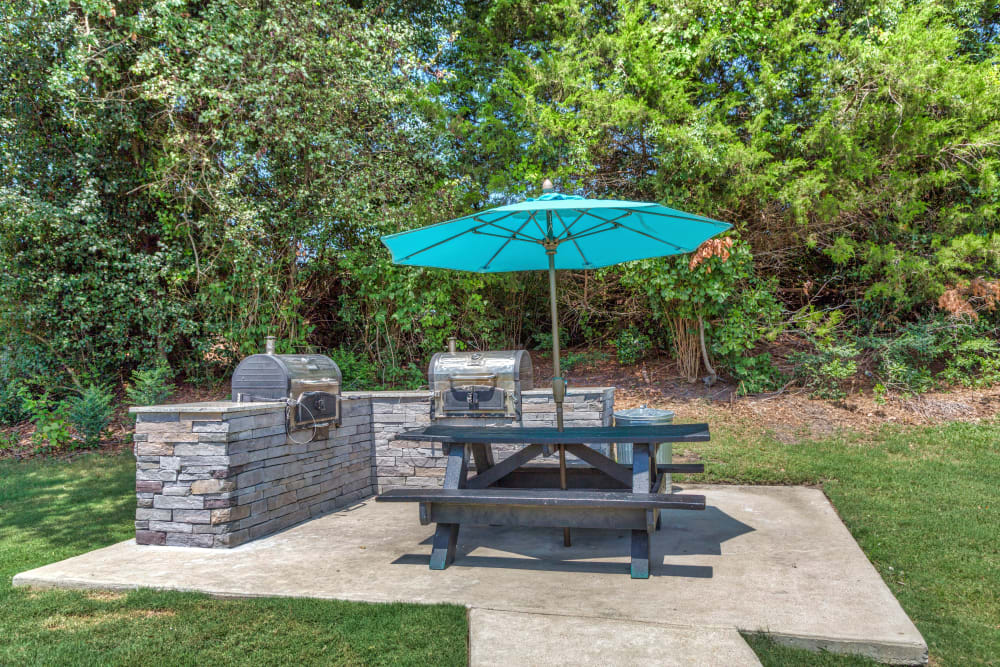 Outdoor picnic area with gas grills at Morganton Place Apartment Homes in Fayetteville, North Carolina