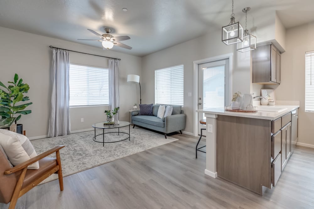 Living room and kitchen of a beautiful model apartment at Olympus at Ten Mile in Meridian, Idaho