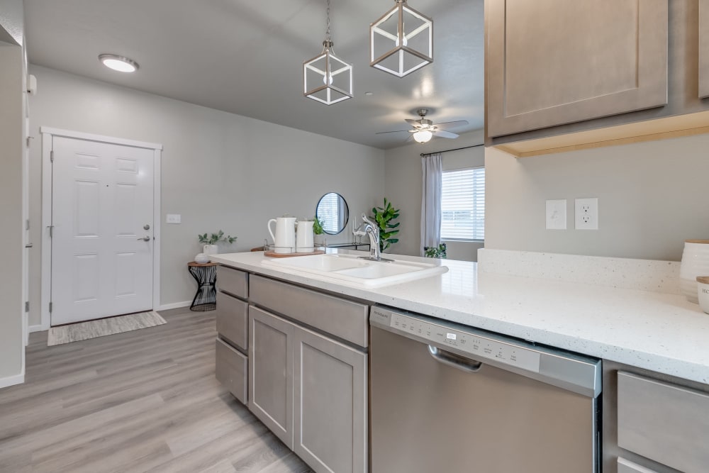 Kitchen with pendant lighting, dishwasher, and designer cabinetry at Olympus at Ten Mile in Meridian, Idaho
