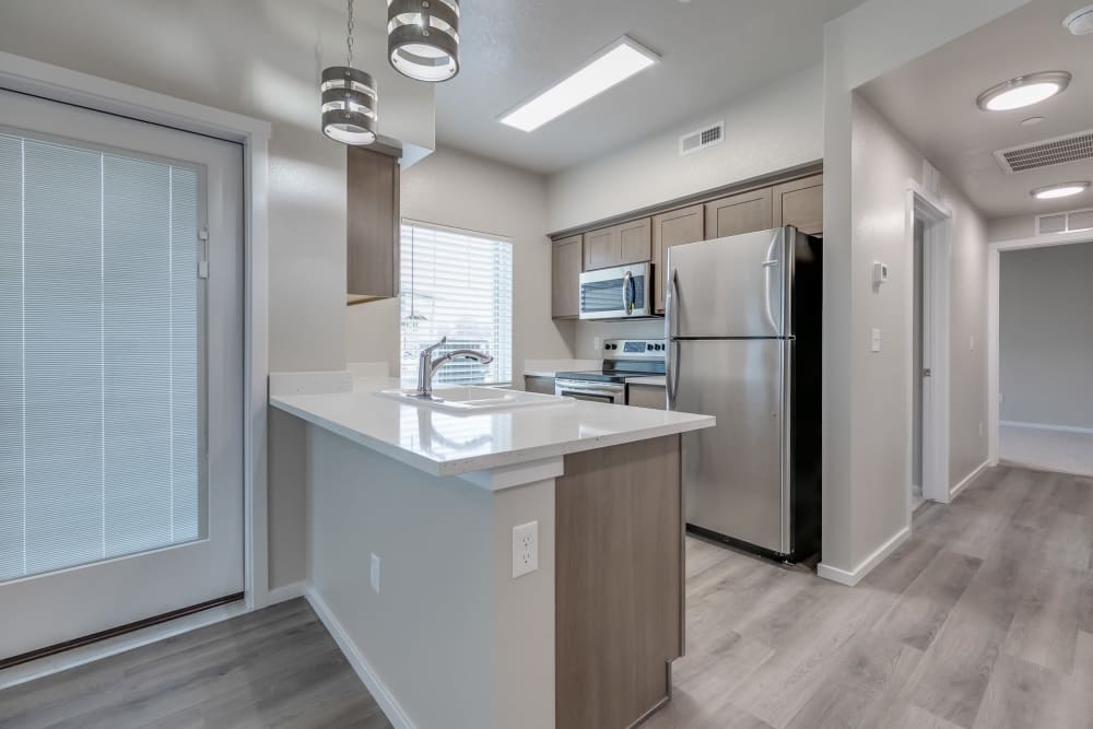 Kitchen with quartz countertops and stainless steel appliances at Olympus at Ten Mile in Meridian, Idaho