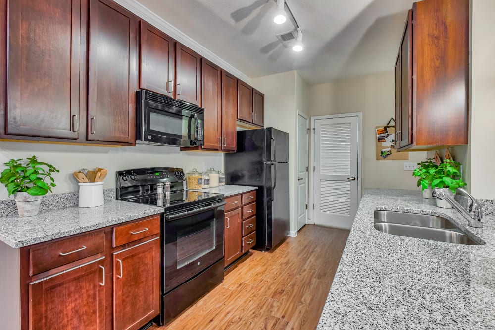 Model Kitchen at Oasis at Montclair Apartments in Dumfries, Virginia