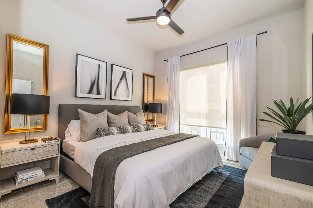 Bedroom with a ceiling fan and large windows at Vidorra McKinney Avenue in Dallas, Texas