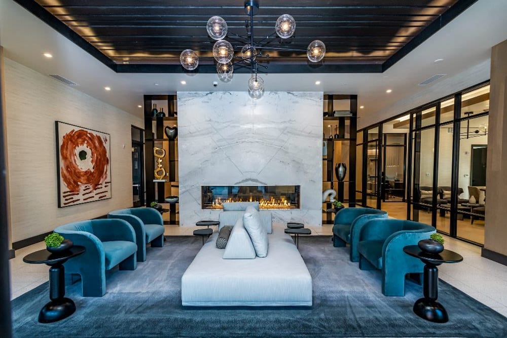 Modern lounge with seating and a fire place at Vidorra McKinney Avenue in Dallas, Texas