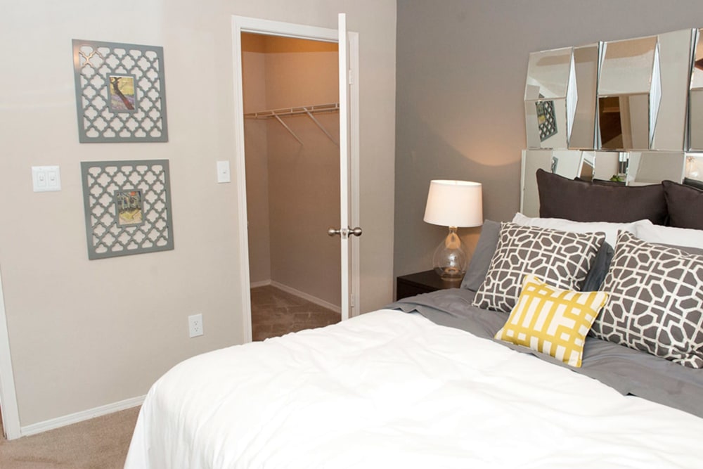 Model bedroom with a spacious walk-in closet at Castlegate Collier Hills in Atlanta, Georgia