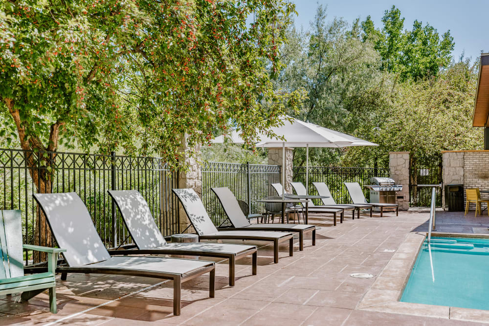 Lounge chairs by the pool at Isabella Apartment Homes in Greenwood Village, Colorado