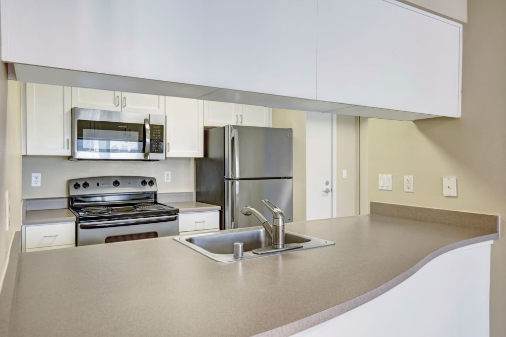 Expansive countertop space in a model home's kitchen at Vantage Park Apartments in Seattle, Washington