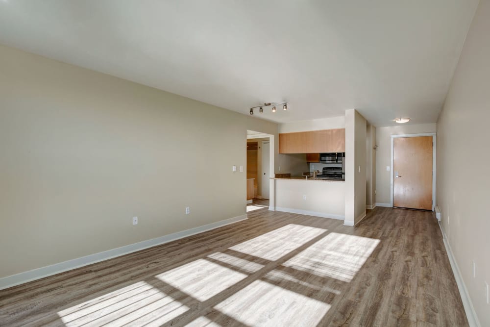 Spacious open-concept model home's living area sporting luxurious hardwood flooring at Vantage Park Apartments in Seattle, Washington