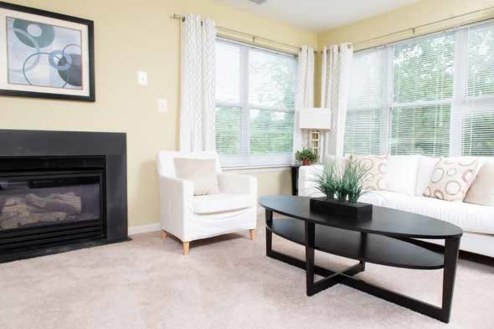 Living room with a fireplace to help you stay warm on a cold night at The Village of Churchills Choice in Upper Marlboro, Maryland