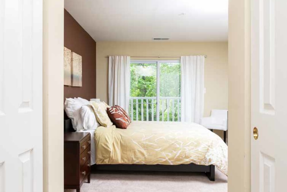 Cozy bedroom with large window and lots of natural light at The Village of Churchills Choice in Upper Marlboro, Maryland