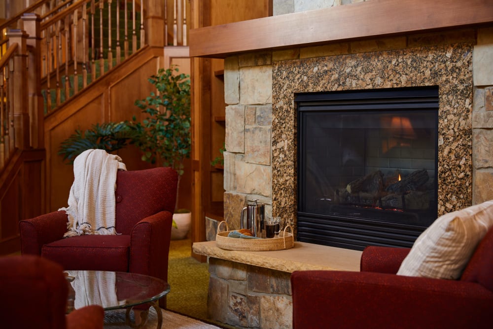 Fireside seating in the lounge at Amira Choice Roseville in Roseville, Minnesota