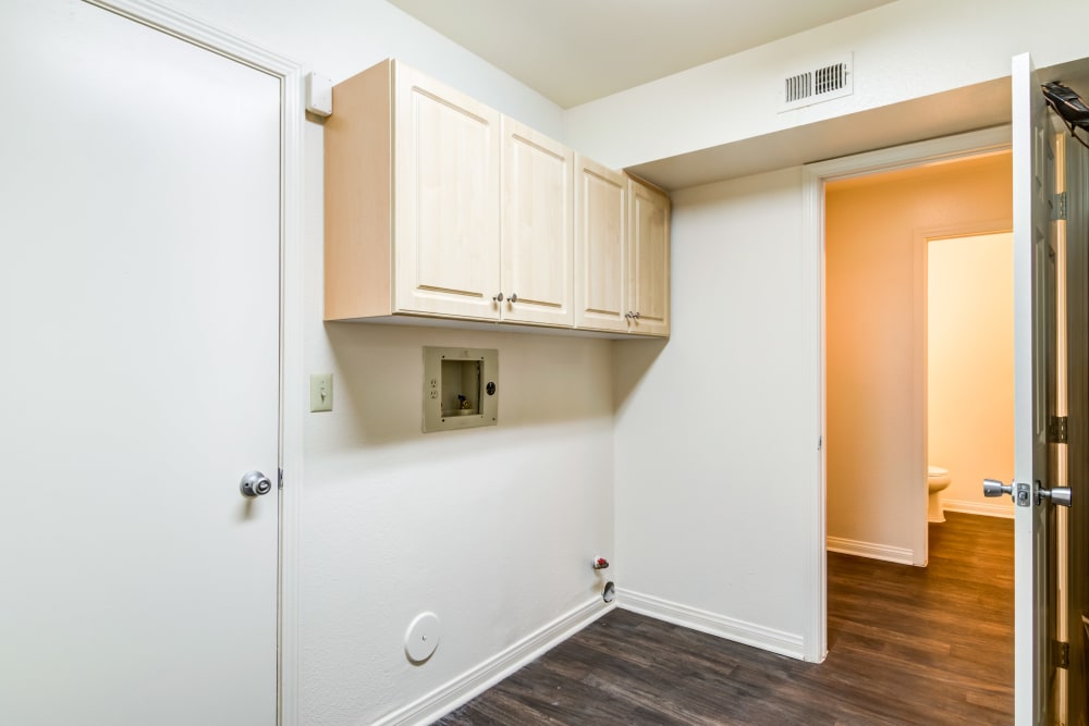 Laundry area with washer and dryer hookups in a home at O'Neill Heights East in Oceanside, California