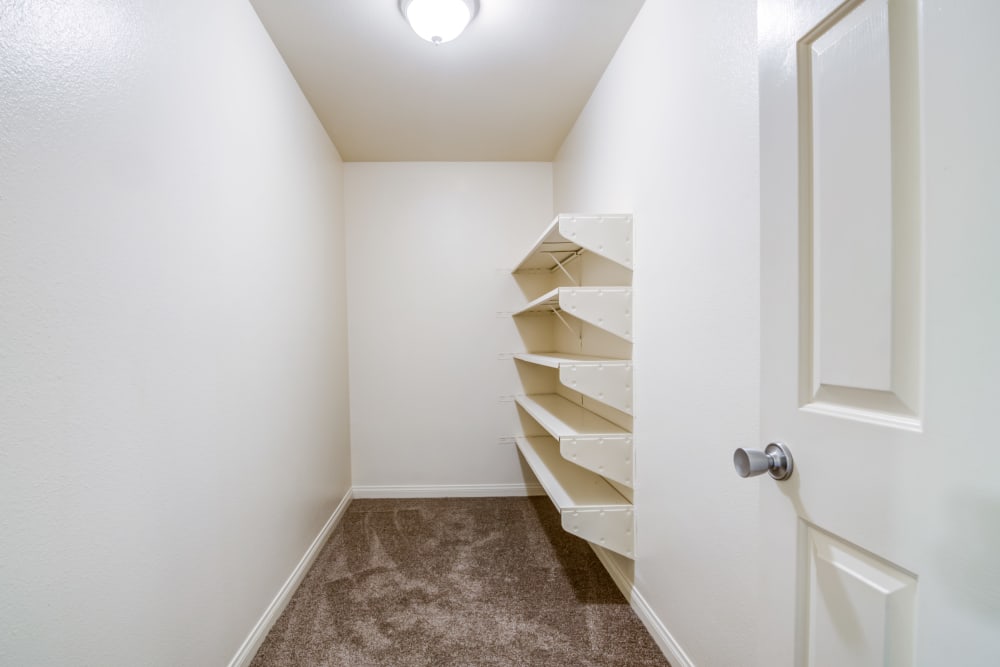 Walk-in closet with storage shelves in a home at O'Neill Heights East in Oceanside, California