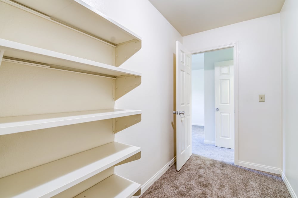 Looking at shelves and outside of walk-in closet towards interior of a home at O'Neill Heights East in Oceanside, California