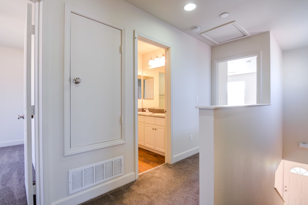 Closet space and a bathroom off a hallway at Harborview in Oceanside, California