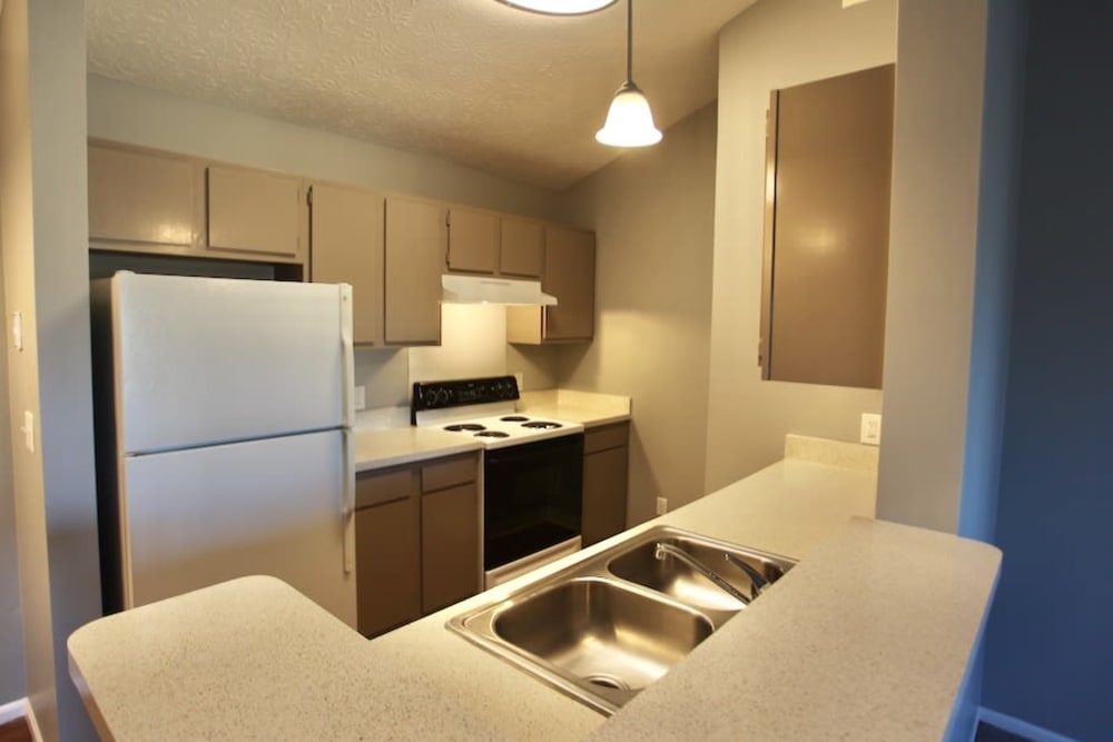 Fully equipped kitchen with double stainless steel sinks and pendant lighting at Trotter's Landing in Delaware, Ohio
