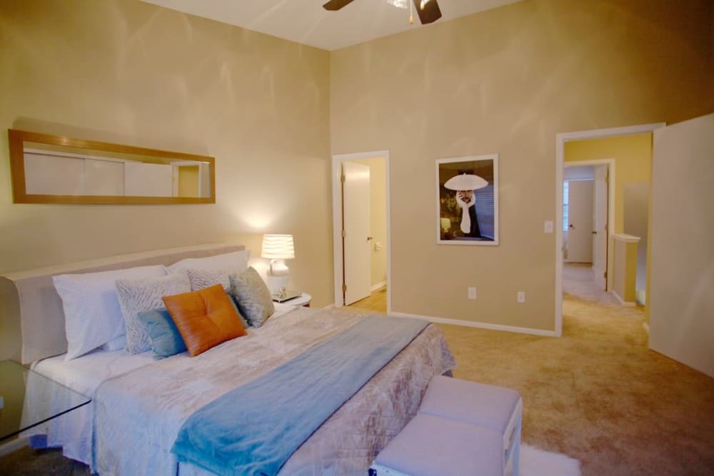 Model bedroom with plush carpeting and ensuite bathroom at Lakeside at the Sanctuary in Columbus, Ohio