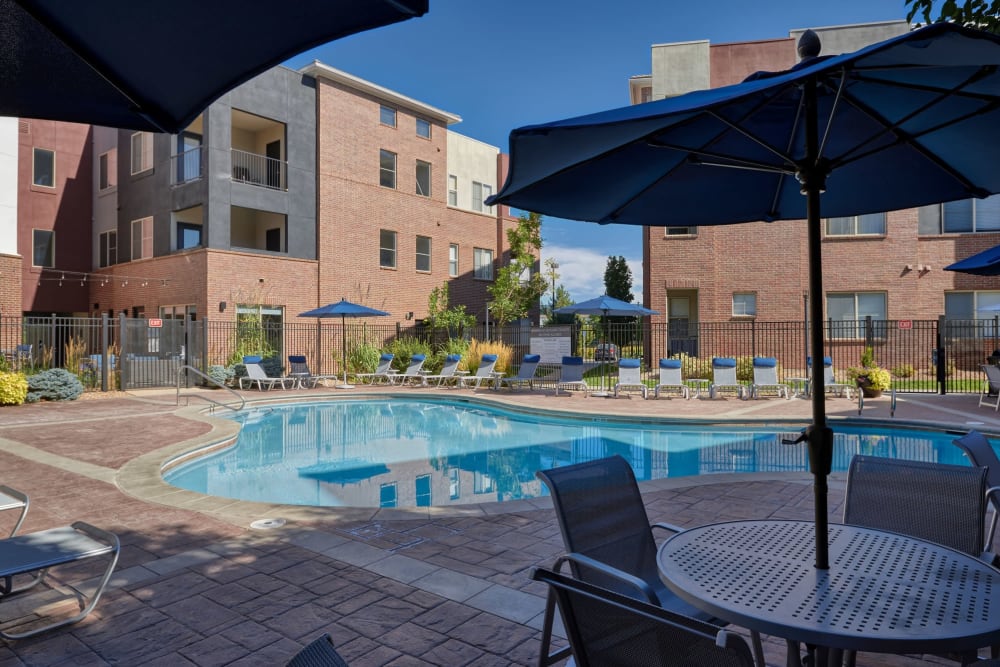 Nice pool with shaded tables and chairs to relax in right on the side at Marq Inverness in Englewood, Colorado