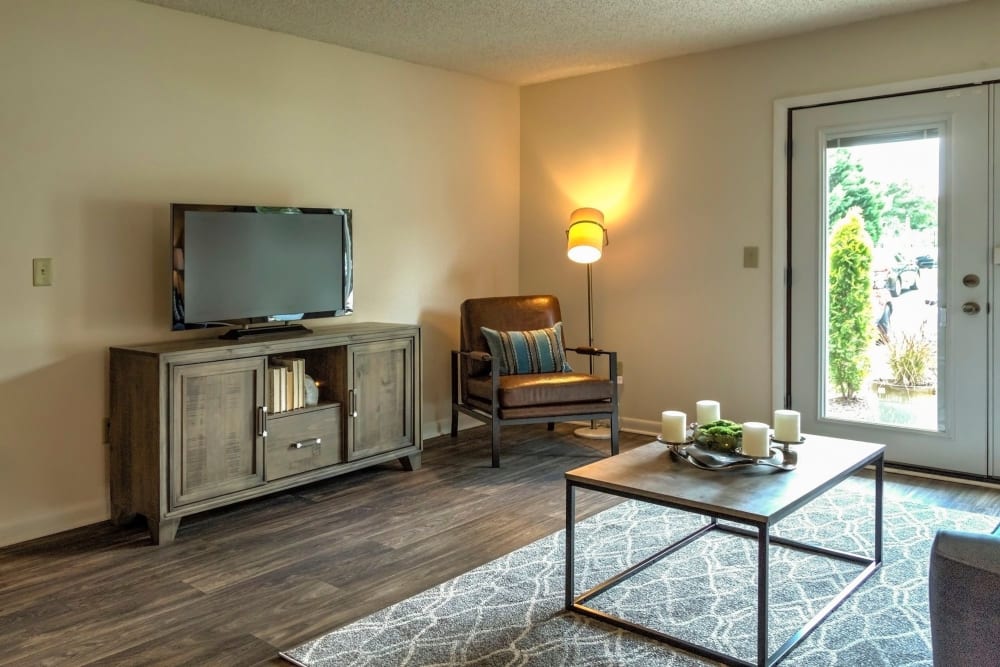 Model living room with access to a private patio at The Village at Cliffdale Apartment Homes in Fayetteville, North Carolina