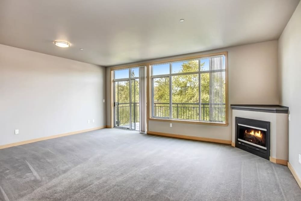 Beautifully carpeted flooring throughout the living room that comes with a fireplace at 700 Broadway in Seattle, Washington