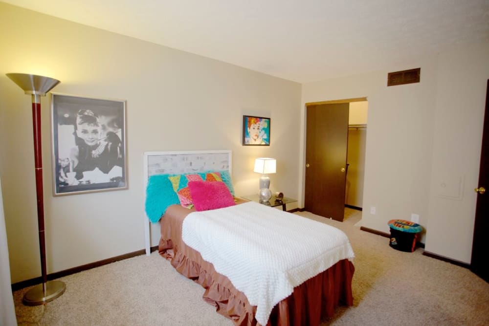 Carpeted model bedroom with a large closet at Riverdale Plaza in Columbus, Ohio