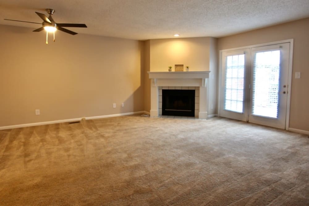 Spacious carpeted living room with a fireplace at Parkhill Luxury Apartments in Columbus, Ohio