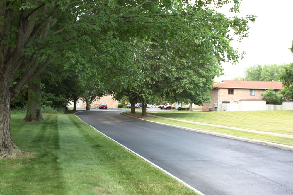 Driveway of McNaughten Plaza lined with trees and an expansive lawn in Columbus, Ohio