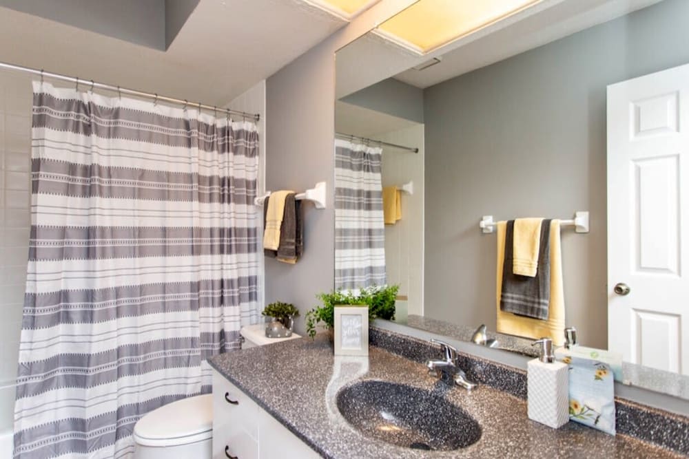 Bathroom with an oversized vanity and tiled shower/tub combination at McNaughten Woods in Columbus, Ohio
