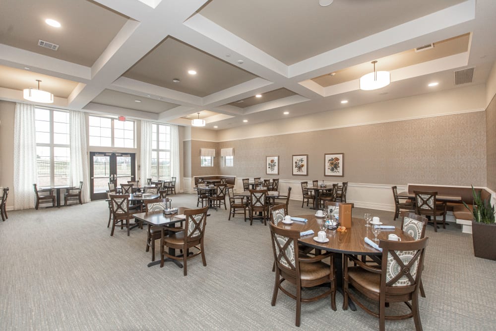 Spacious dining room with tall ceilings and plenty of seating at The Madison Senior Living in Kansas City, Missouri