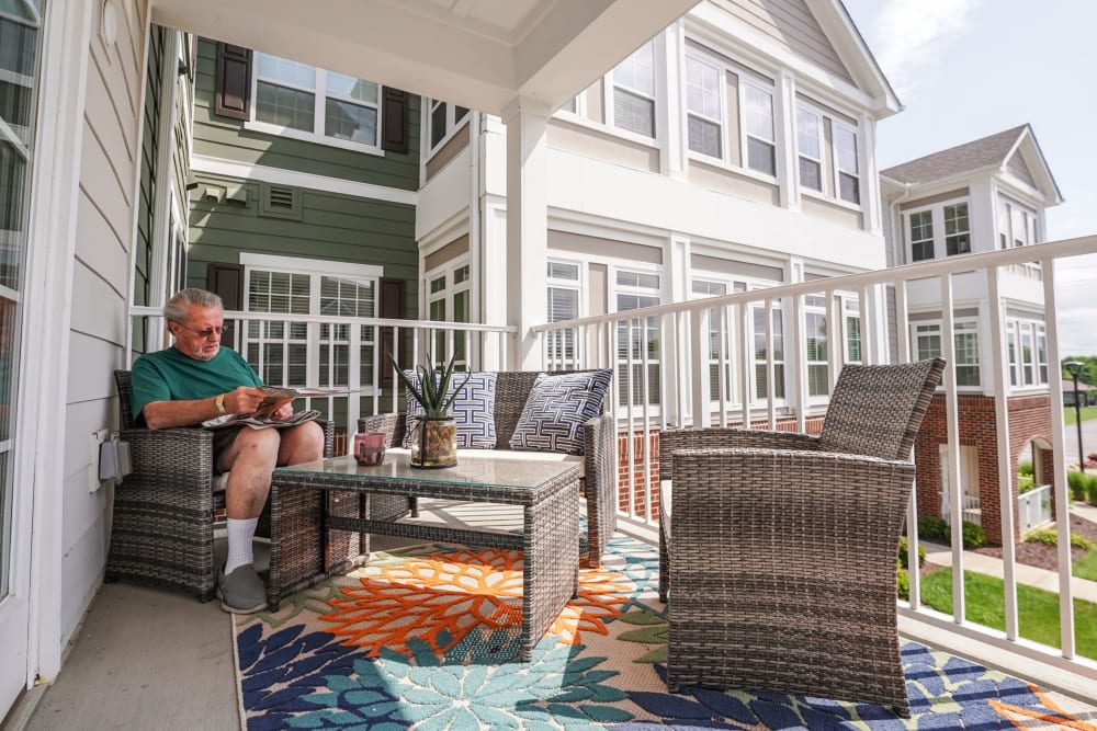 Resident on their balcony at Harmony at Five Forks in Simpsonville, South Carolina
