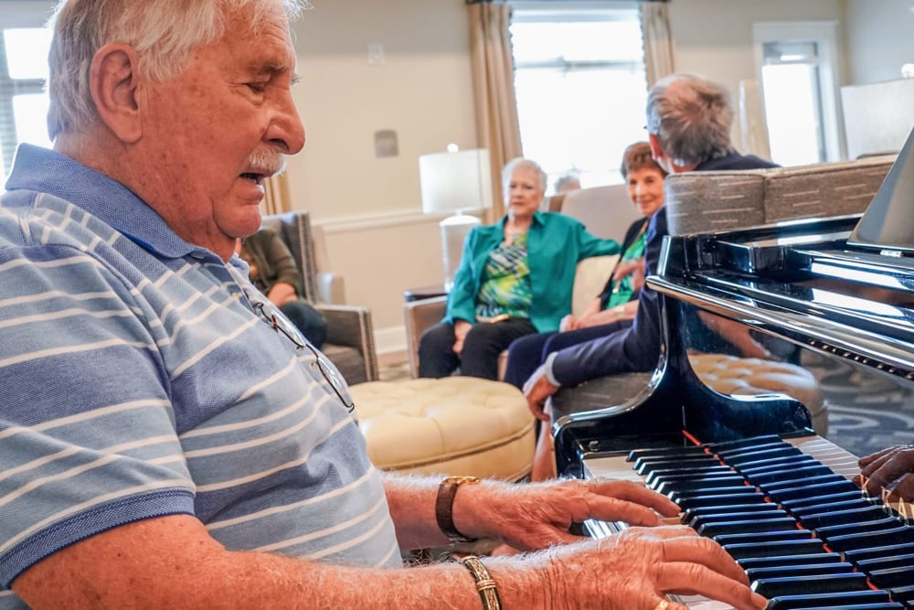 Resident playing piano Harmony at Harbour View in Suffolk, Virginia