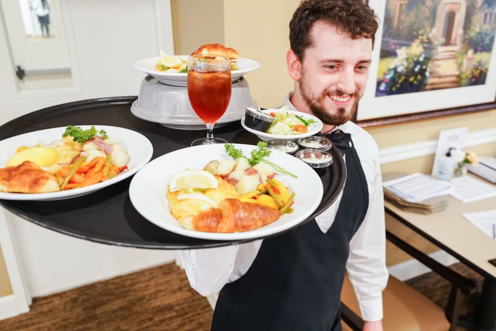 Server with meals at Harmony at Martinsburg in Martinsburg, West Virginia