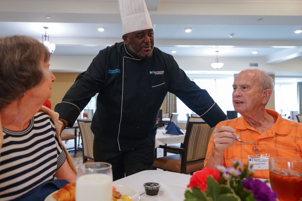 Chef talking with residents in the dining room Harmony at Morgantown in Morgantown, West Virginia