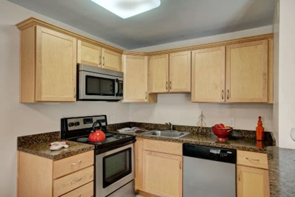 Model kitchen with stainless steel appliances at Ridley Brook Apartments in Folsom, Pennsylvania