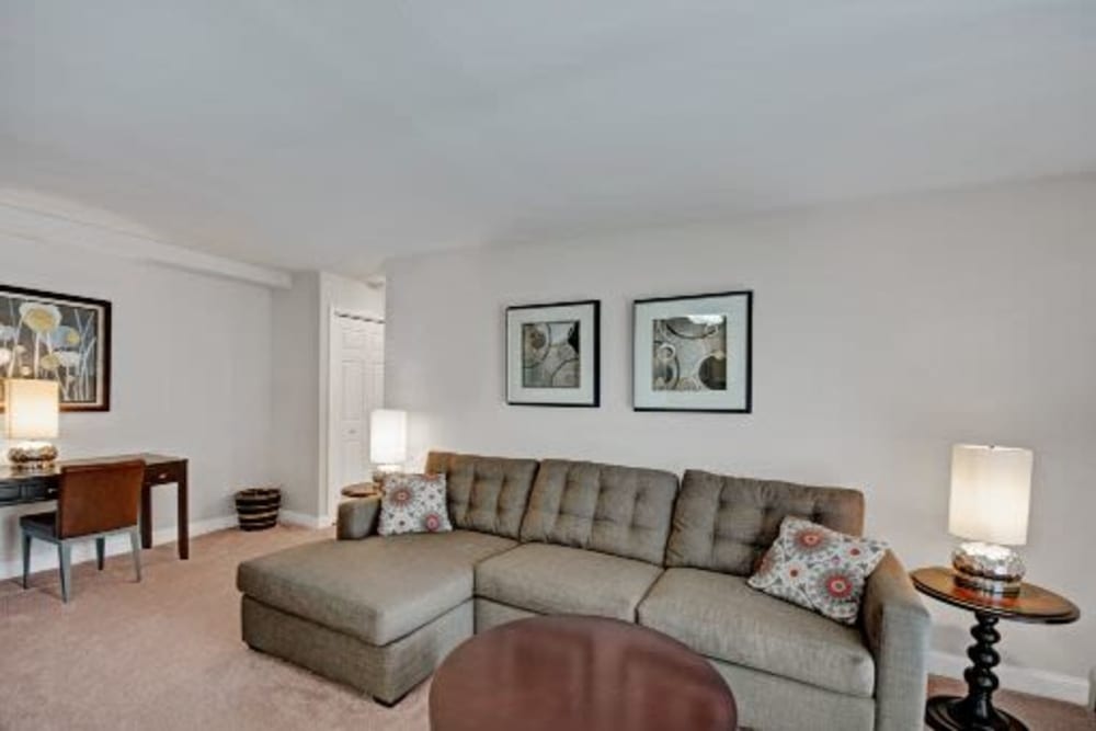 Spacious living room with a couch and a coffee table at Ridley Brook Apartments in Folsom, Pennsylvania