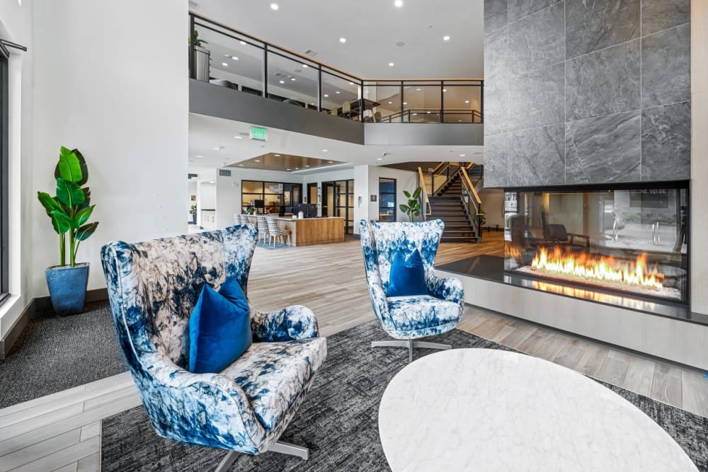 Modern lobby with seating and a fire place at The Verge in Auburn, Washington